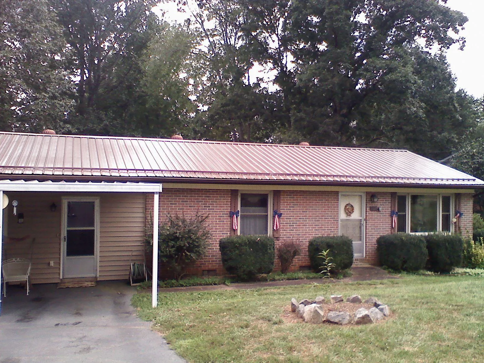 Bronze metal roof and carport on a brick ranch home — Roof Repair work by our crew in Shakopee